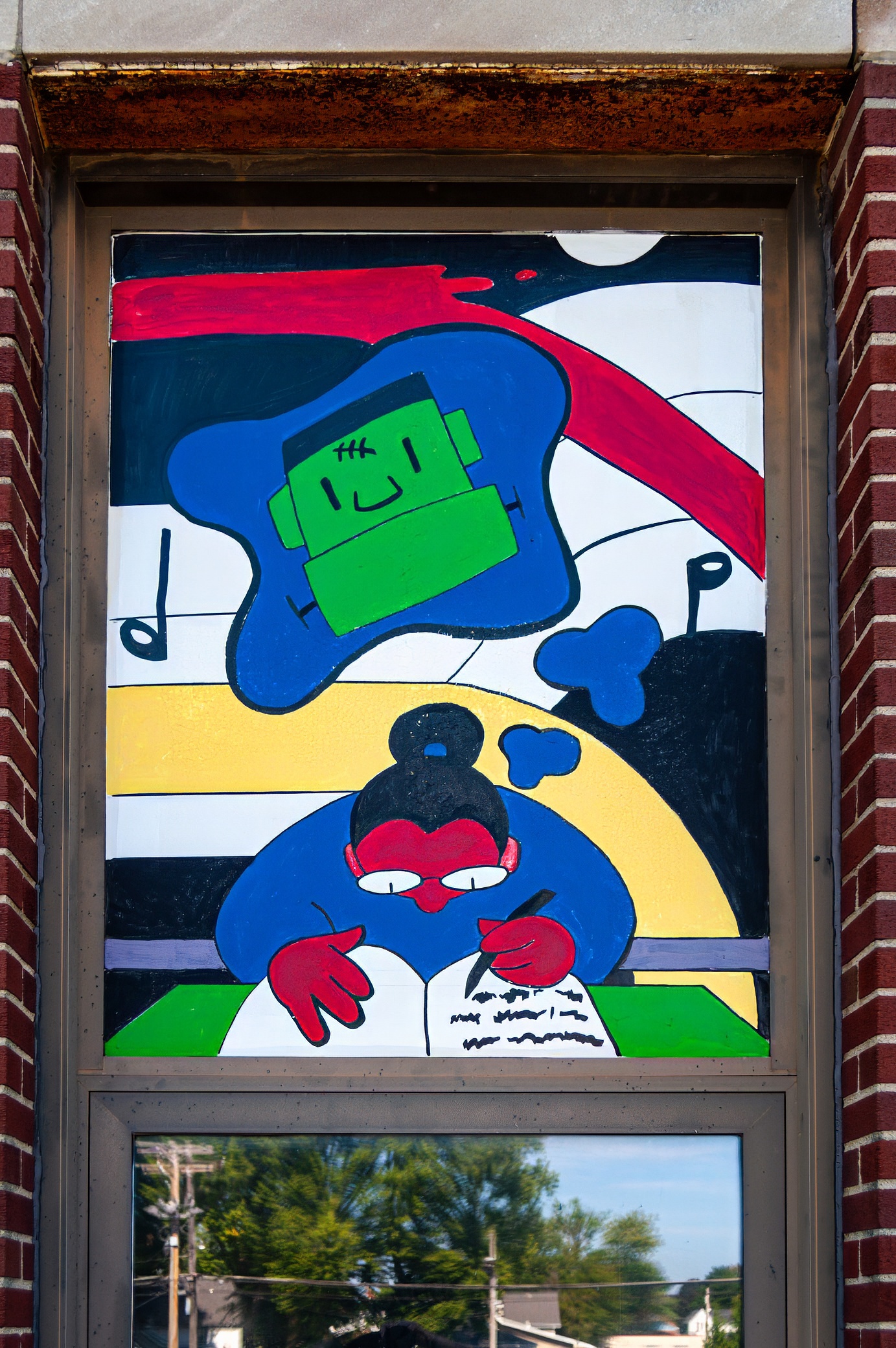 A colorful mural depicting a character writing in a notebook, with a smiling green monster above, set in a vibrant background of various colors.
